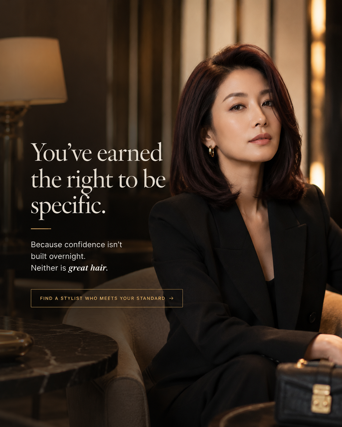 Rich Auntie Energy — Asian woman in a tailored blazer with a sleek warm burgundy blowout, luxury hotel lobby